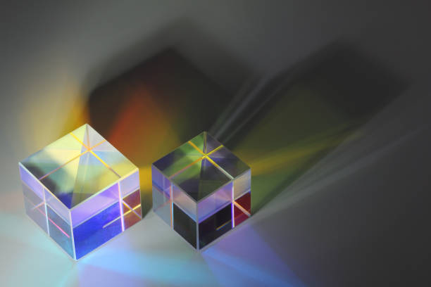 istock Two glass prism cubes close-up refract light and cast colored shadows 1199077875