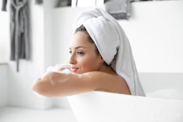 istock Young woman in bath 1199080215