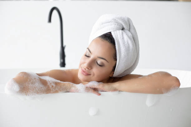 istock Woman relaxing in bathtub 1199080379