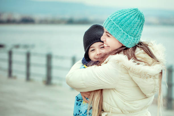 istock cold weather mother hugging son 1199080711
