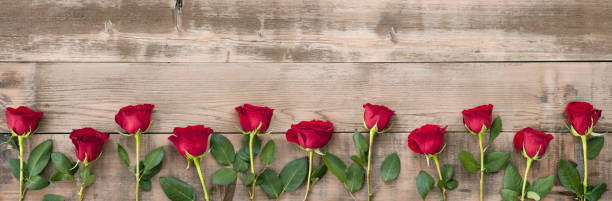 istock Valentine's Day Red Rose Banner on Old Wood Background 1199080957