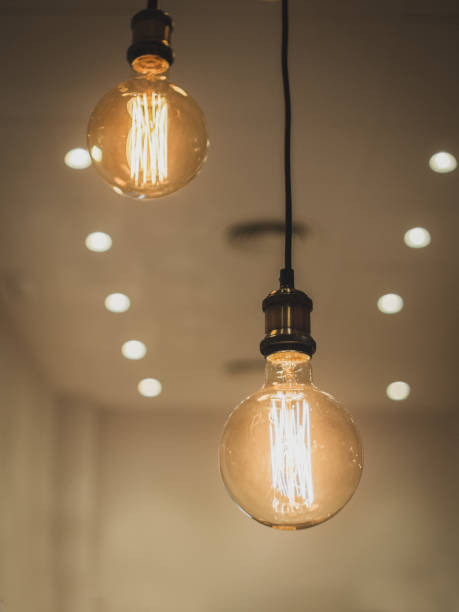 istock Close-up hanging decorative retro bulb at a coffee bar with blurred background 1199081934