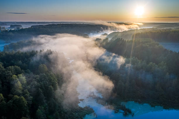 istock Flying above stunning mist over river in autumn at sunrise 1199083344