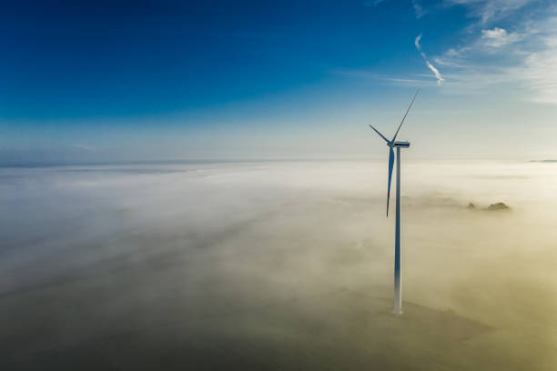 istock Fog and wind turbines at sunrise in autumn 1199083400