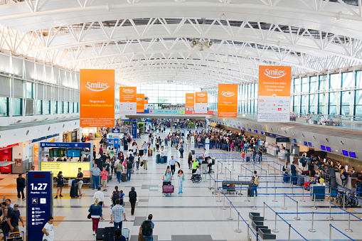 Buenos Aires, Argentina November 2019: International departure hall at Ezeiza, Buenos Aires international airport, with travelers walking, checking in and waiting.