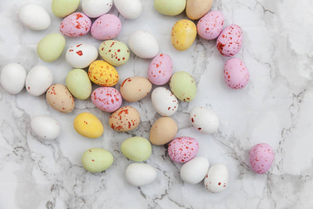istock Happy Easter concept. Preparation for holiday. Easter pastel candy chocolate eggs sweets on trendy gray marble background. Simple minimalism flat lay top view copy space 1199084545