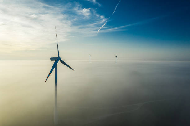 istock Wind turbines over mist at sunrise in Poland 1199084613