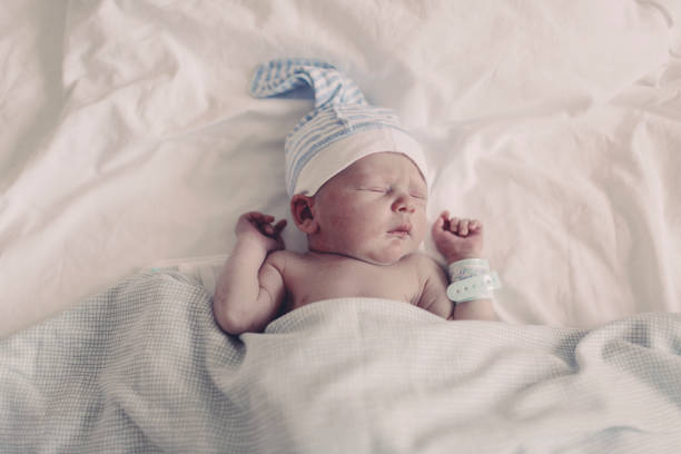 Newborn baby with bracelet stock photo