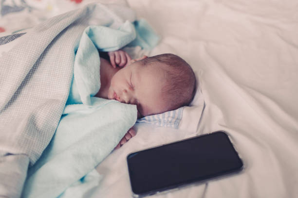 istock Newborn baby sleeping in hospital 1199085402