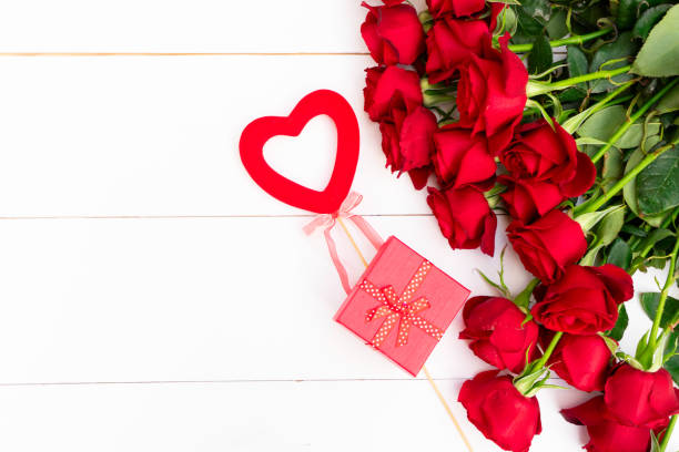 istock Red blooming roses on wood 1199087497