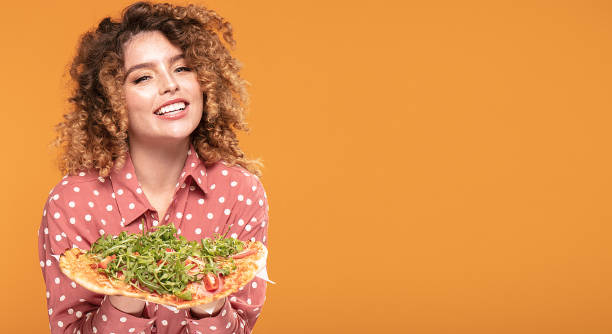 istock Happy smiling young woman with pizza. 1199087744