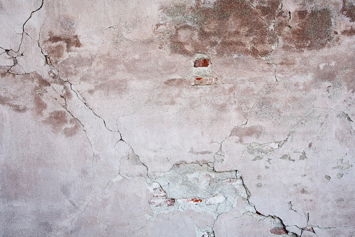 Old plastered brick wall, aged and weathered, abstract texture background