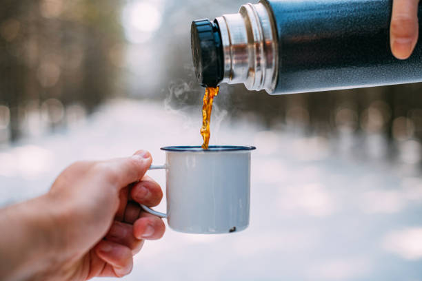istock Thermos and Coffee in Snowy Forest 1199093622