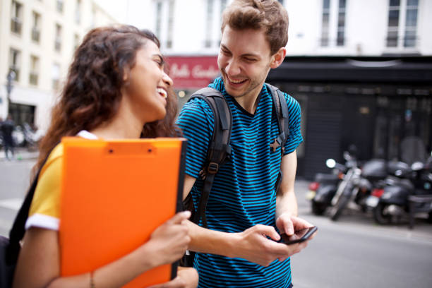 istock college students laughing with mobile phone 1199097283