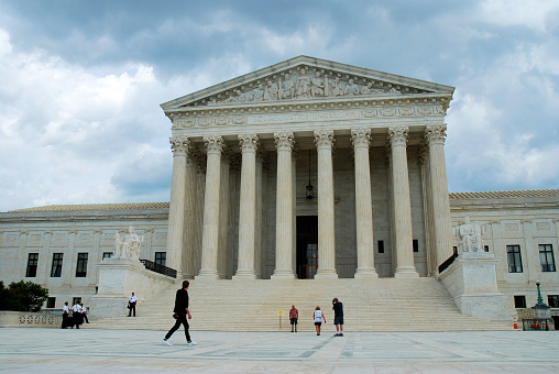 This impressive building was completed in 1935 and was designated a National Historic Landmark in 1987.  The Supreme Court of the United States is the highest court in the federal judiciary of the United States of America.  It is also the official workplace and residence of the Supreme Court Justices of the United States.  This image was captured during May of 2019 on an overcast day in Washington, D.C.