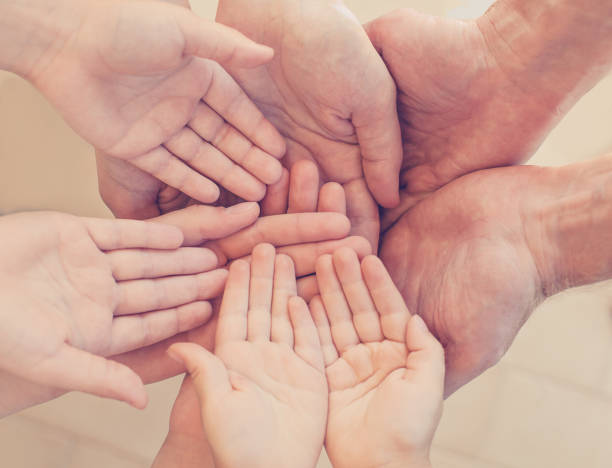 istock Many hands together: group of people joining hands 1199100008
