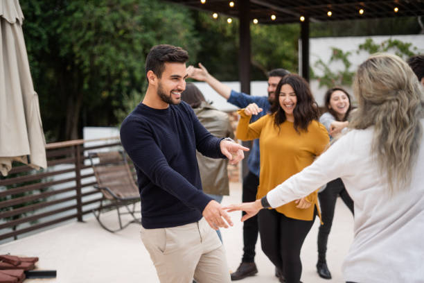 istock Group of friends dancing at outdoors barbecue party 1199100375