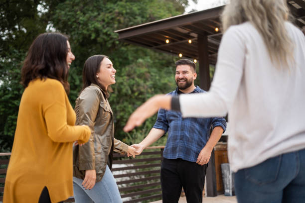 istock Friends dancing and laughing together 1199100381