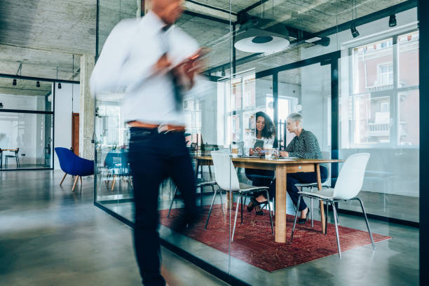 istock Business meeting at busy corporate office. 1199100511