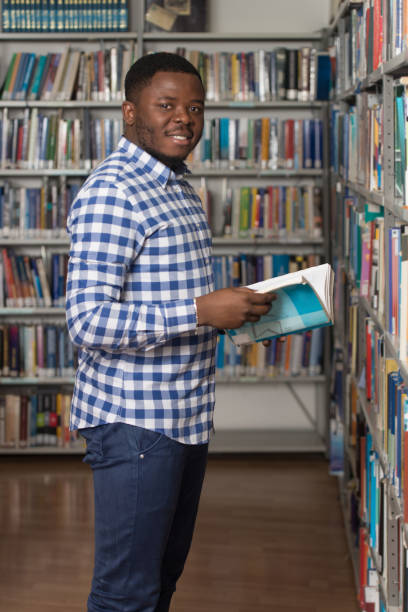 istock Male College Student In A Library 1199100535