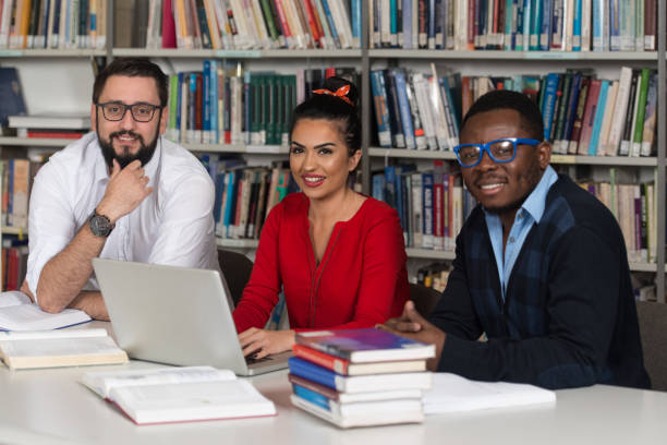 istock Couple Of Students In A Library 1199100550