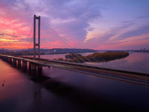 istock Traffic on a bridge. Modern metropolis with intersection of the traffic trails on a bridge. Traffic jams of roadside, transportation motion in a big city. 1199103351