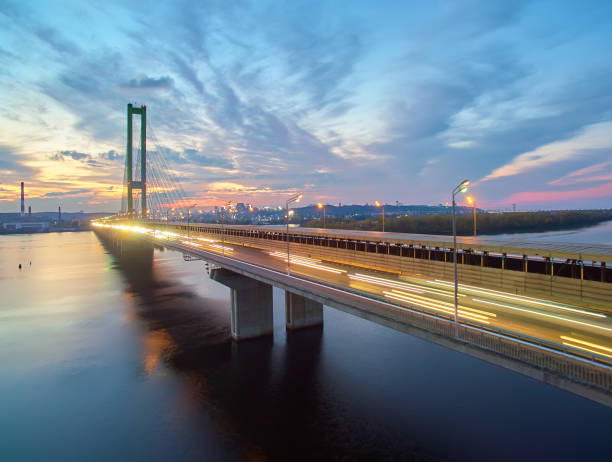 istock Traffic on a bridge. Modern metropolis with intersection of the traffic trails on a bridge. Traffic jams of roadside, transportation motion in a big city. 1199103356