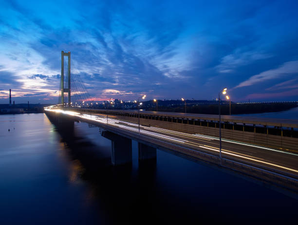 istock Traffic on a bridge. Modern metropolis with intersection of the traffic trails on a bridge. Traffic jams of roadside, transportation motion in a big city. 1199103363