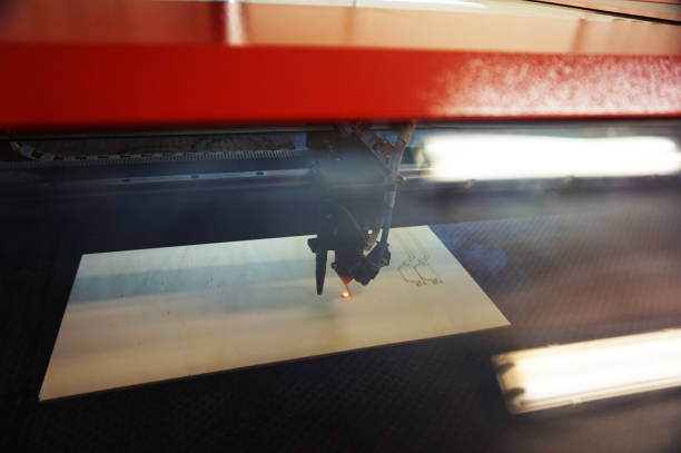 istock laser light is cutting wood 1199103534