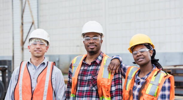 istock Three construction workers in hardhats and safety vests 1199107429