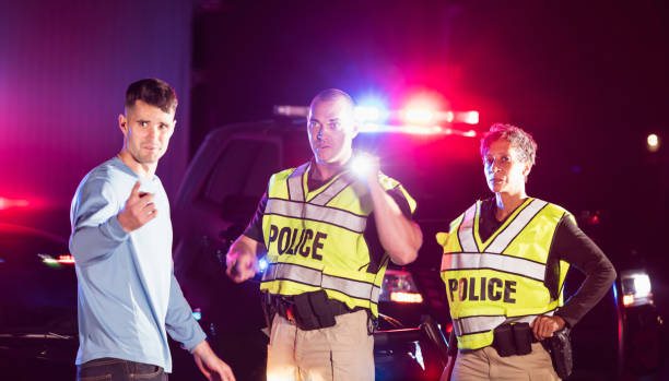 istock Police officers at night talking with young man 1199110047