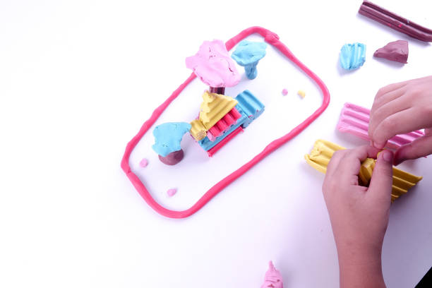 istock Child hands playing with colorful clay. 1199110844