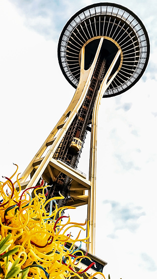 A mesmerizing portrait of the infamous Space Needle in Seattle - towering above the Seattle Proper and Lower Queen Anne neighborhoods - amidst a stunning Chihuly original glass sculpture.