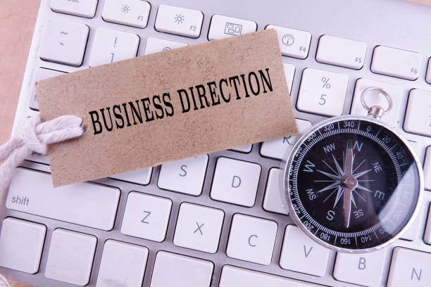 istock BUSINESS DIRECTION CONCEPT with keyboard, brown tag and compass. 1199118331