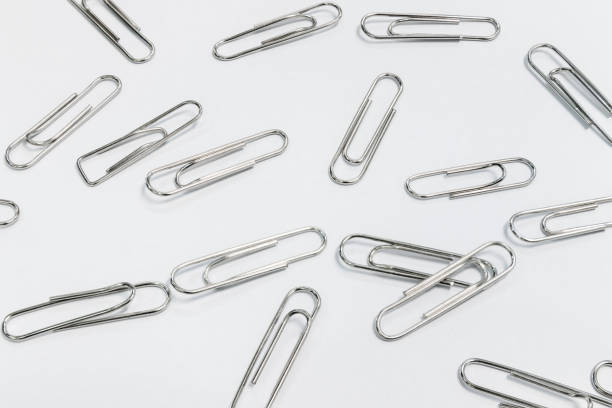 istock Many Gem paper clips are placed on white paper under the neon lights. 1199122959