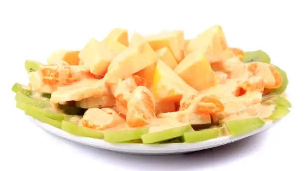 Fresh  fruit,Plate of homemade yogurt with fresh  mandarin orange,banana,apple,kiwi and mango  isolated on white background