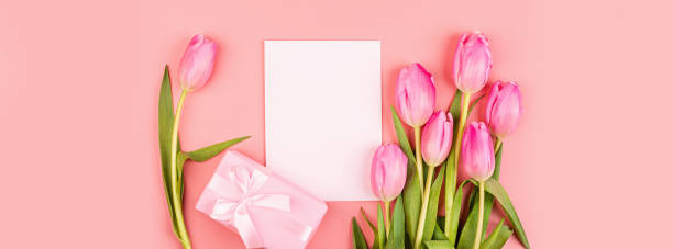 istock View from above tulips and gift box with copy space. Background for womens day, 8 March Valentines day, 14 february. Flat lay style, top view, mockup, template, overhead. Greeting card 1199128873