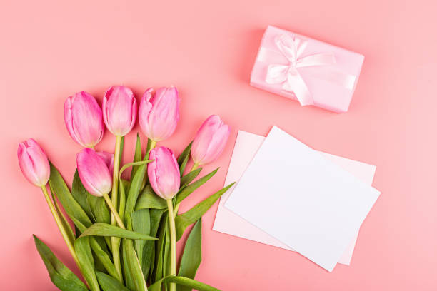 istock View from above tulips and gift box with copy space. Background for womens day, 8 March Valentines day, 14 february. Flat lay style, top view, mockup, template, overhead. Greeting card 1199130439
