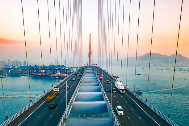 Drone view of Stonecutters Bridge and the Tsing sha highway at sunset Drone view of Stonecutters Bridge and the Tsing sha highway at sunset bridge built structure stock pictures, royalty-free photos & images