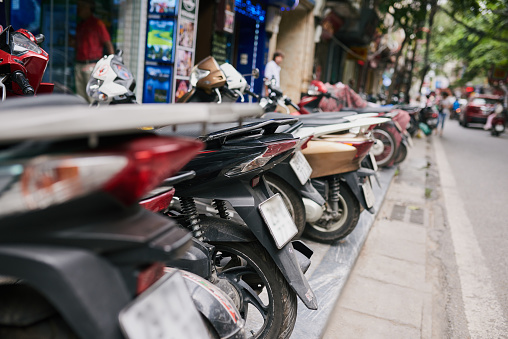 Shot of a row of motorcycles lined up on a sidewalk in Vietnam