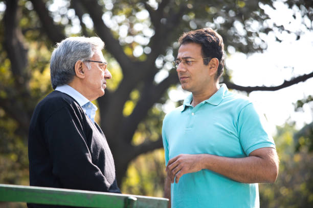 istock Father and son discussing outdoor at park 1199150582