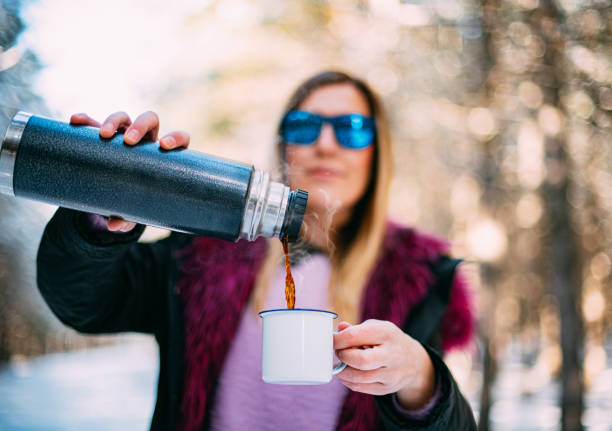 Cute Woman Drinking Coffee in Snowy Forest