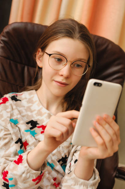 istock young girl communicates on a smartphone 1199153907