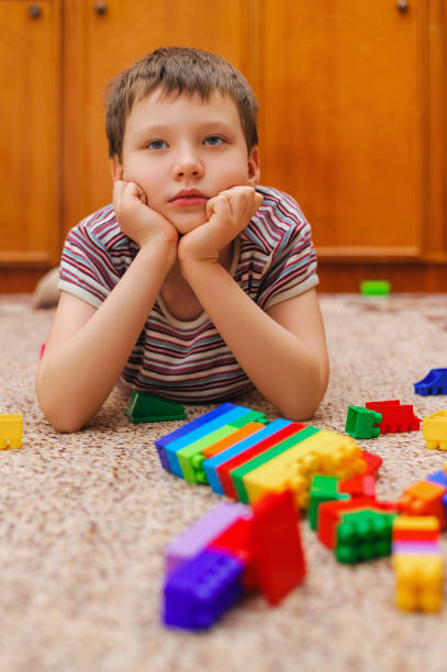 istock sad child near the fallen tower from the constructor 1199156769