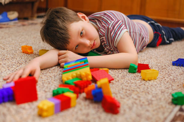 istock sad kid near the fallen tower from the constructor 1199156777