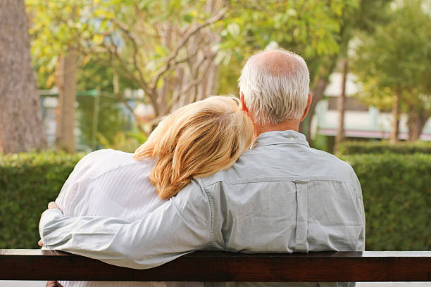 istock Senior couple sitting in the park 119915734