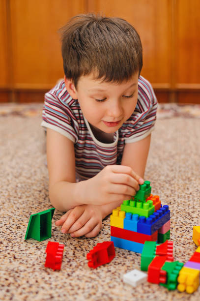 istock concentrated kid builds a tower from the constructor 1199157519