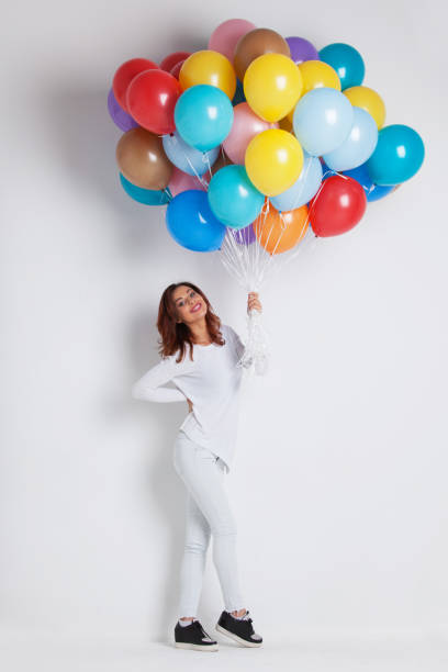 istock Woman with colored balloons 1199157857