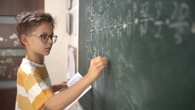 Little boy calculating fractions on math lesson