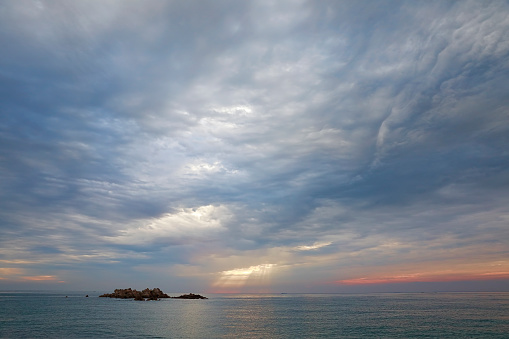 Cloudy sea, island, dawn